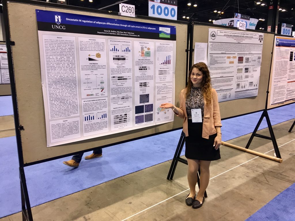 Dana DeSilva stands by her poster during 2017 Experimental Biology Conference