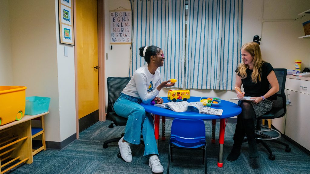 Dr. Shriver and Jahleen with props of junk food and toys